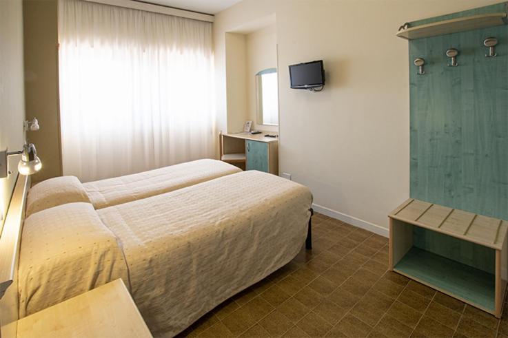 Postel nebo postele na pokoji v ubytování Hotel Scacciapensieri