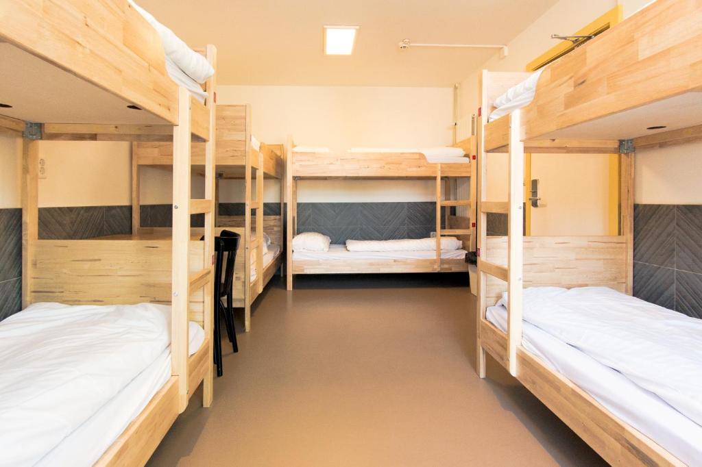 a room with three bunk beds in a hostel at Hostel The Globe in Amsterdam