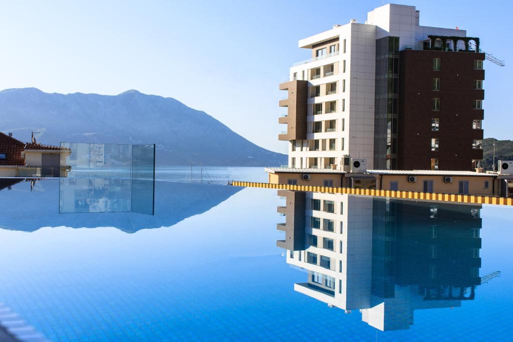 a building sitting on top of a body of water at Hotel Fagus by Aycon in Budva