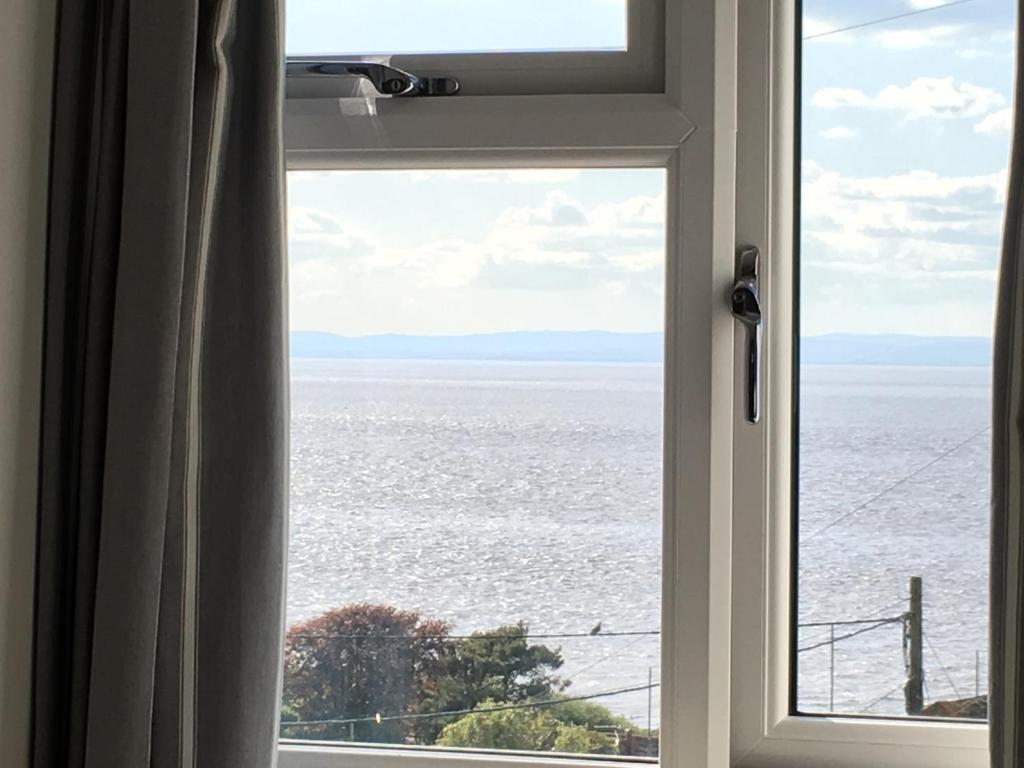 a window with a view of the ocean at The Nook @ Drop Anchor in Portishead