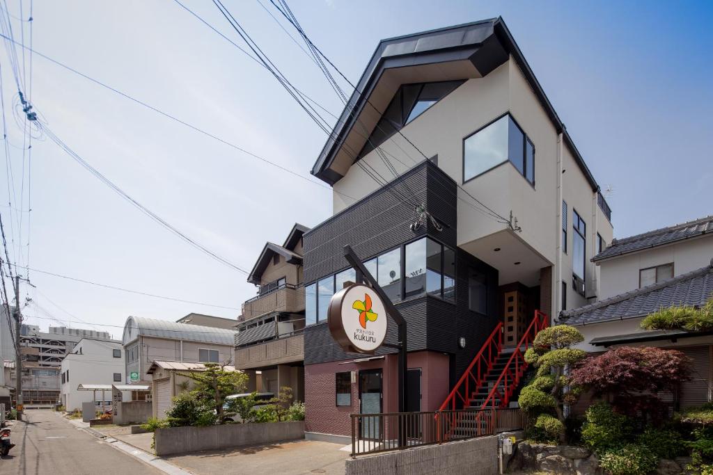 a building with a sign on the side of it at Guesthouse kukuru in Wakayama