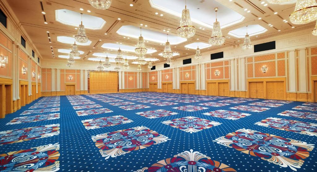 a large room with a blue floor and chandeliers at Nagoya Marriott Associa Hotel in Nagoya