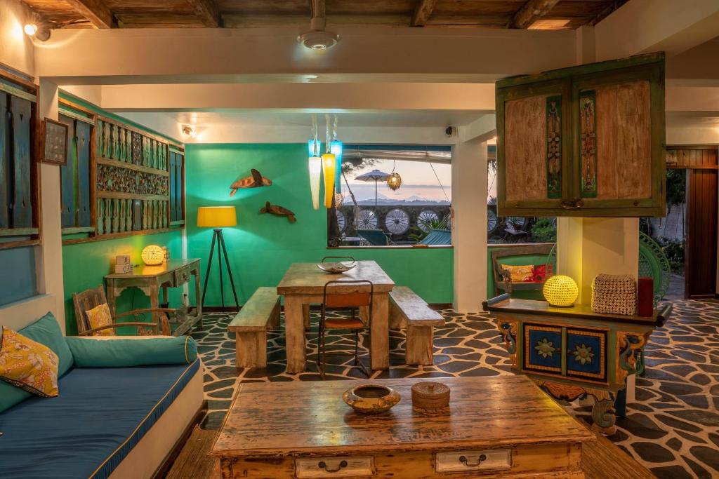 a living room with a couch and a table at Kai's Beach House Villa in Gili Air