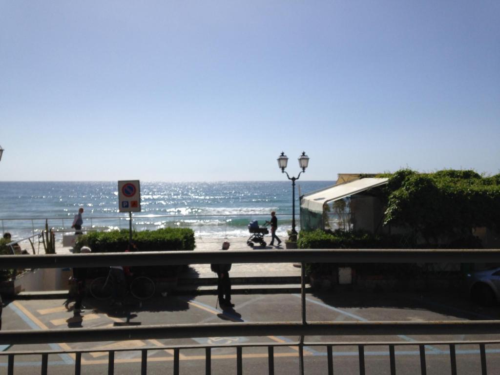 a view of the beach and the ocean from a bus at Residence Atlantic in Alassio