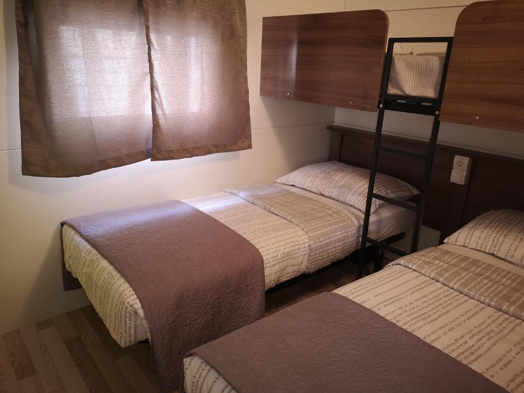 Postel nebo postele na pokoji v ubytování Mobile homes Marita