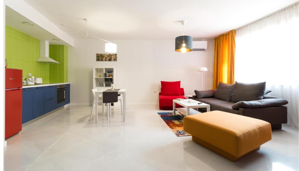 a living room with a couch and a kitchen at Pop your COLORS - Funky and Modern 1BDR Apt by Flat Mаnager in Plovdiv