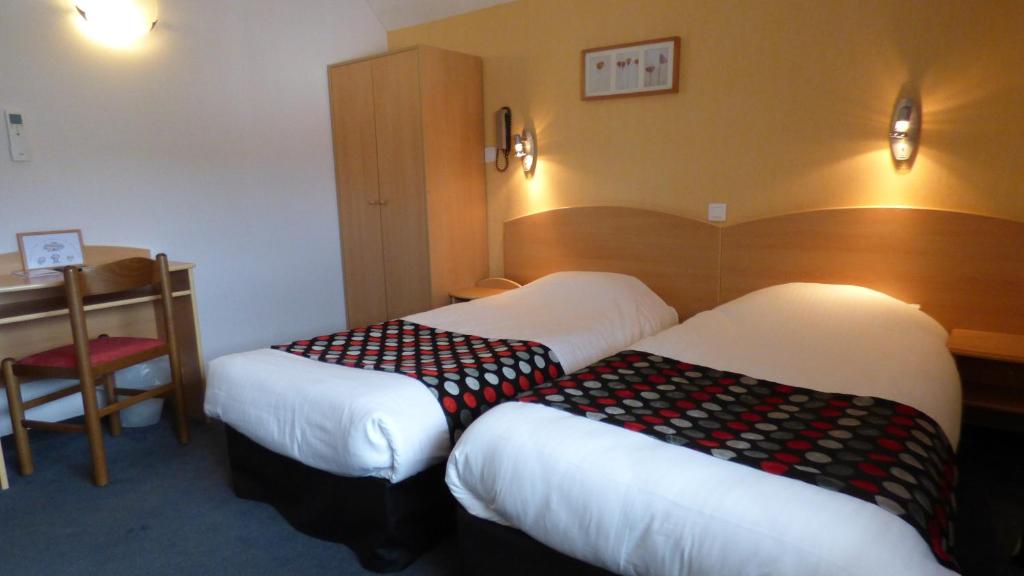 Postel nebo postele na pokoji v ubytování Cit'Hotel de La Vallée