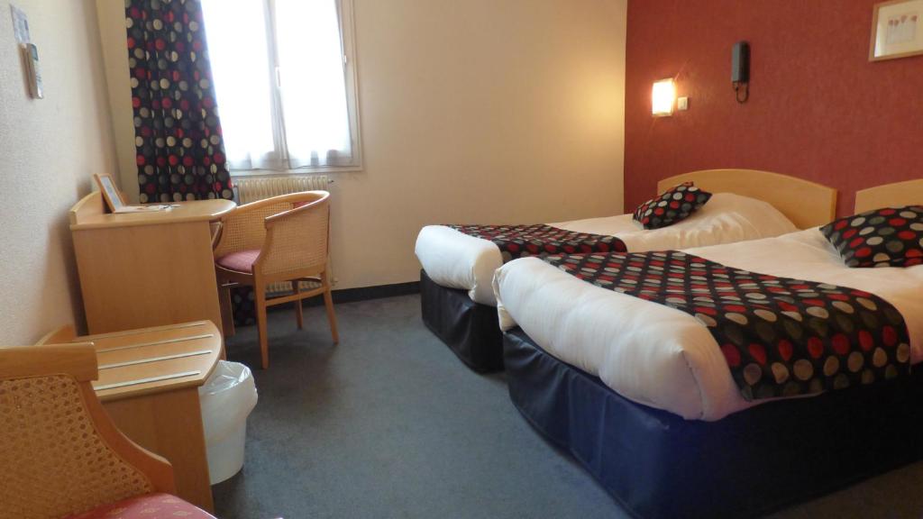 Postel nebo postele na pokoji v ubytování Cit'Hotel de La Vallée