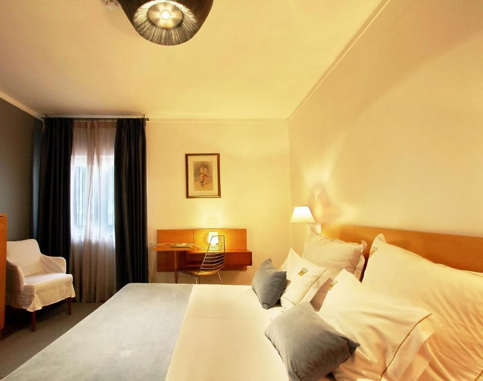 Postel nebo postele na pokoji v ubytování Hotel Mestre de Avis