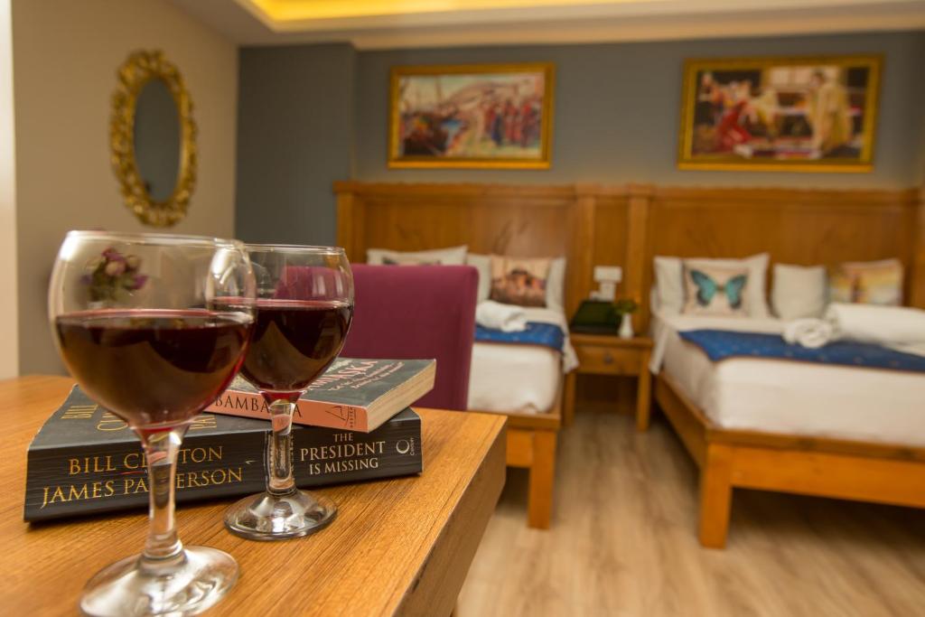 a room with two glasses of wine on a table at The PeraPort Hotel in Istanbul