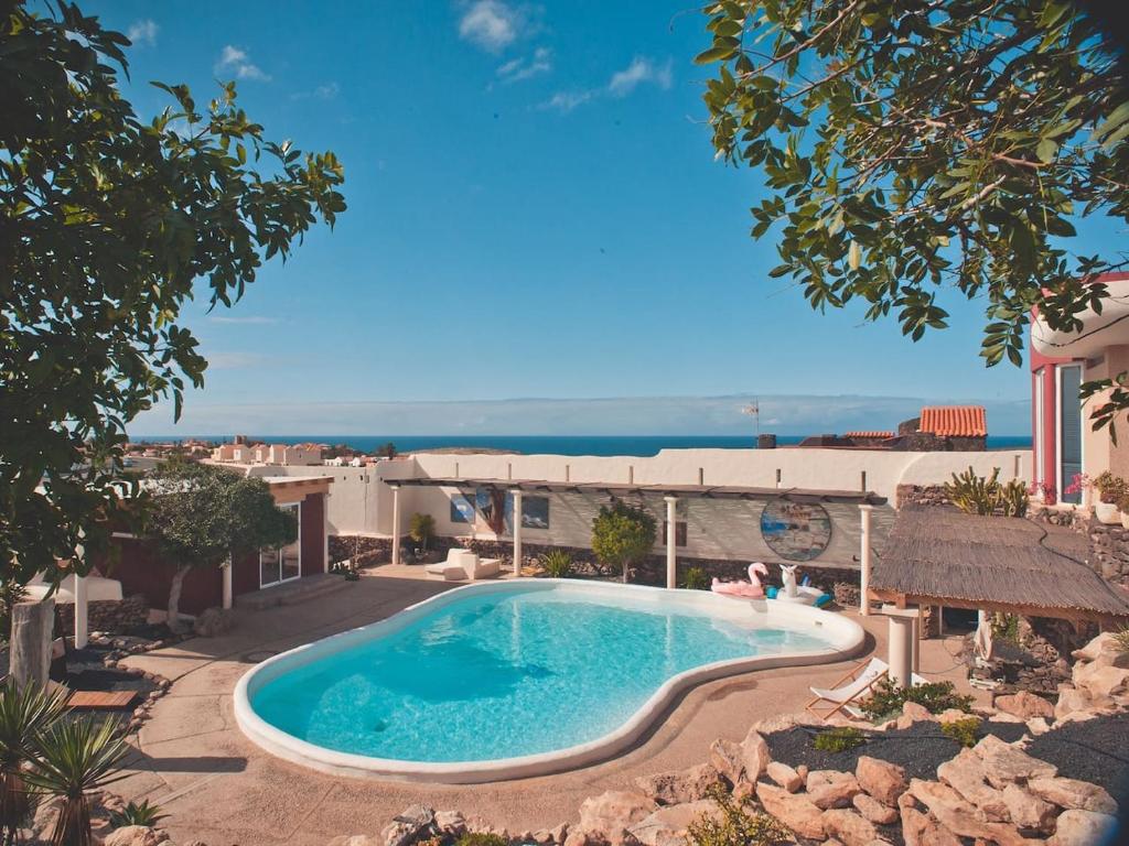 a swimming pool with a view of the ocean at Studio - Agua - Surf & Yoga Villa in La Pared