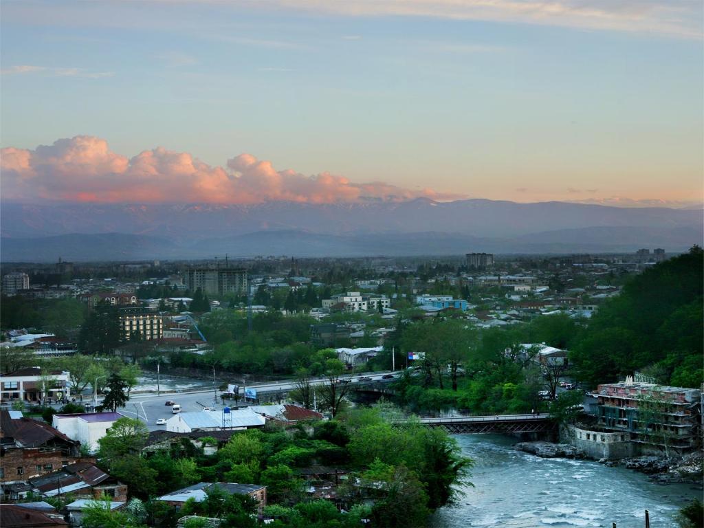 a view of a city with a river and buildings at Hotel Tskhumi in Kutaisi