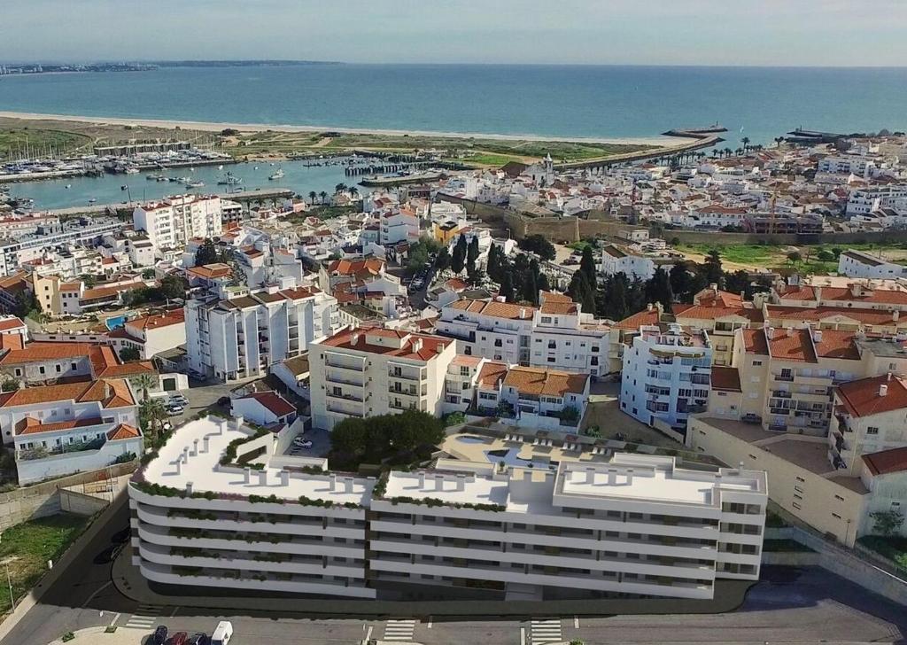 an aerial view of a city with buildings and the ocean at Casa Feliz Lagos in Lagos