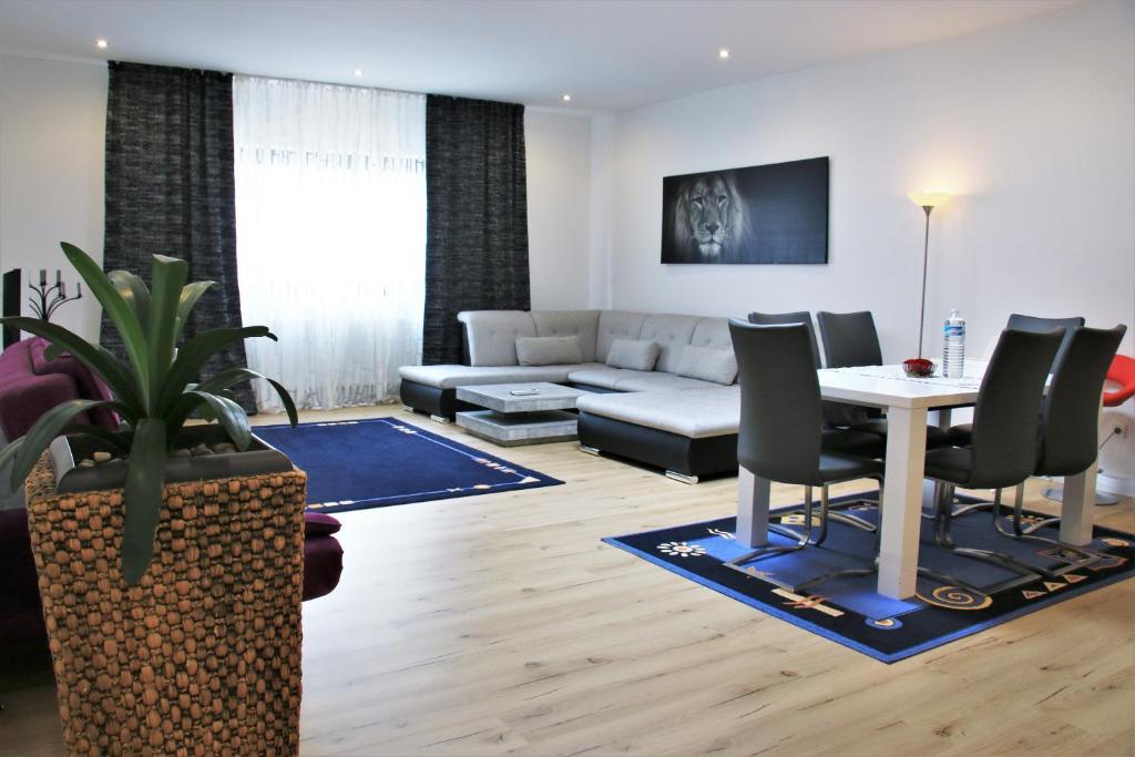 a living room with a couch and a table at Ferienwohnung in Zweibrücken