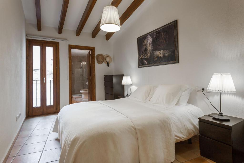 Postel nebo postele na pokoji v ubytování Petit Hotel Alaro