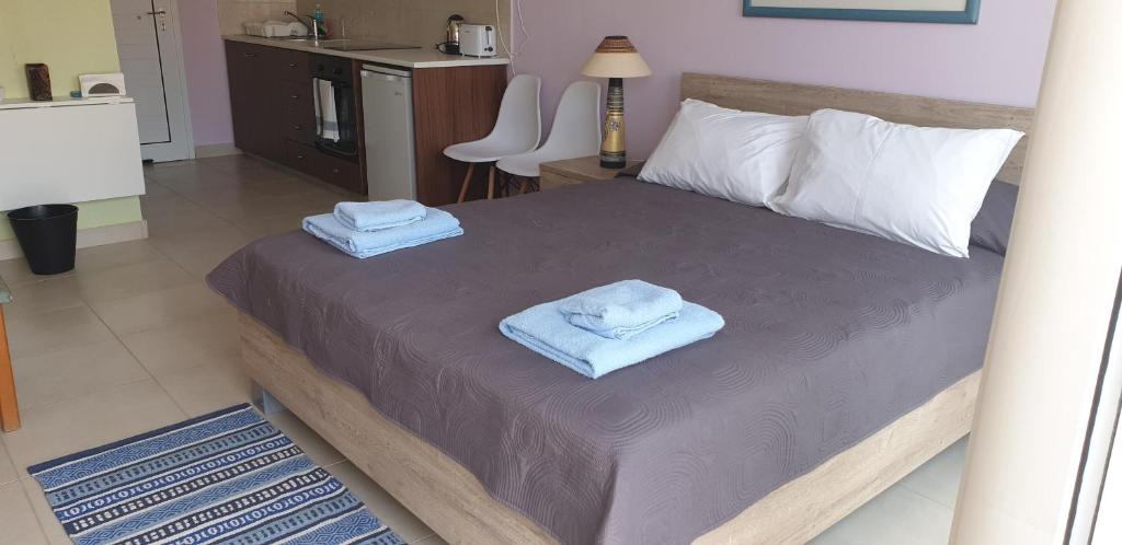 a bedroom with a bed with towels on it at EMILIA 11 STUDIO in Polis Chrysochous