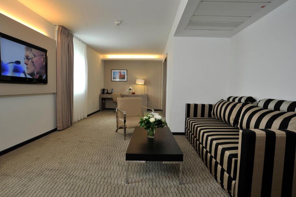 TV a/nebo společenská místnost v ubytování Golden Tulip Kassel Hotel Reiss