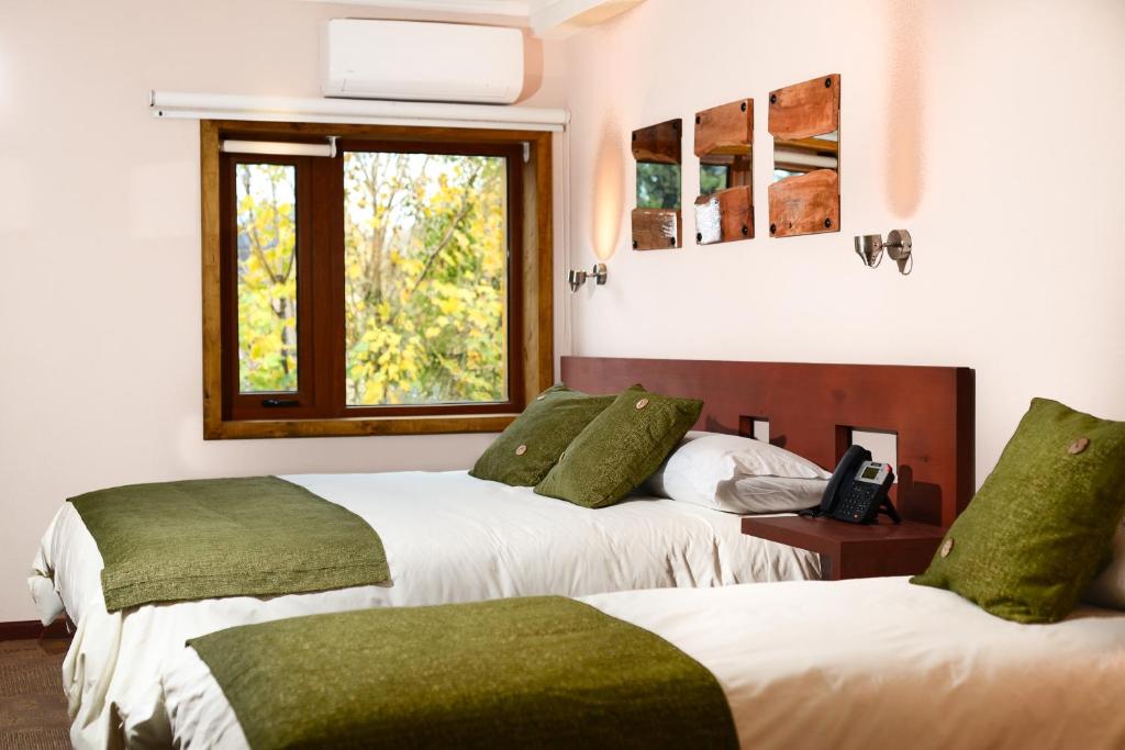 Cama o camas de una habitación en Hotel Pucón Indómito