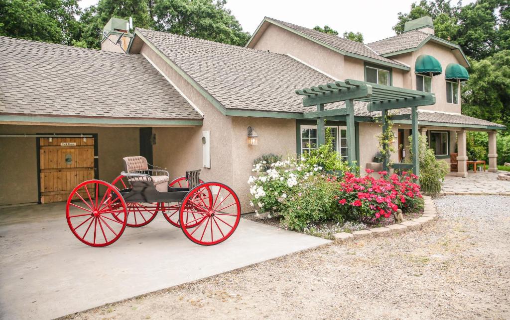 a red carriage in front of a house at The Eden House Vineyard in Templeton
