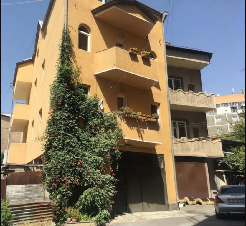 a building with a christmas tree in front of it at Yerevan's Heart in Yerevan