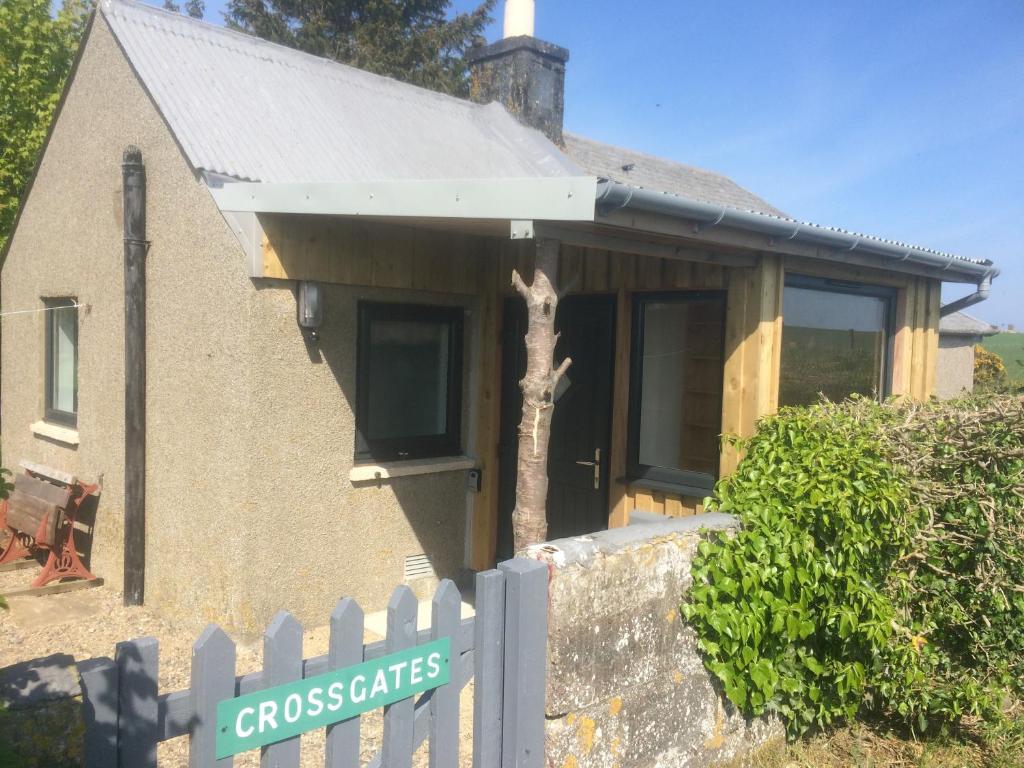 a house with a fence in front of it at Crossgates, Rosehearty in Rosehearty