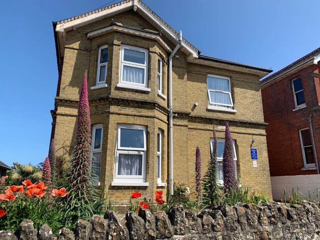 a brick house with flowers in front of it at Number 29 - Only Adults in Shanklin