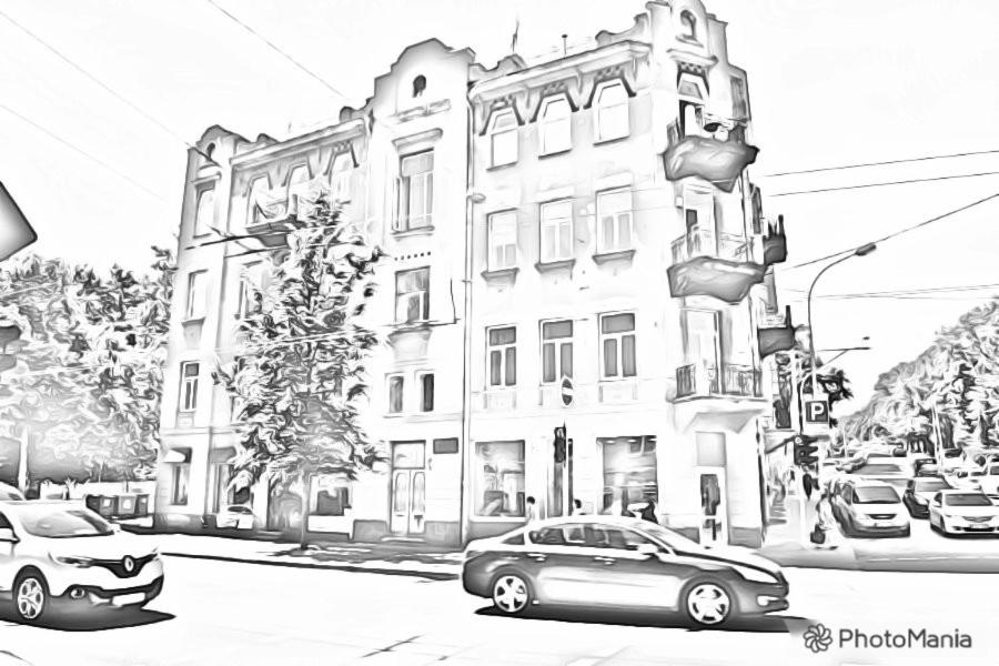 a black and white photo of a building on a street at Vilnius centre house in Vilnius