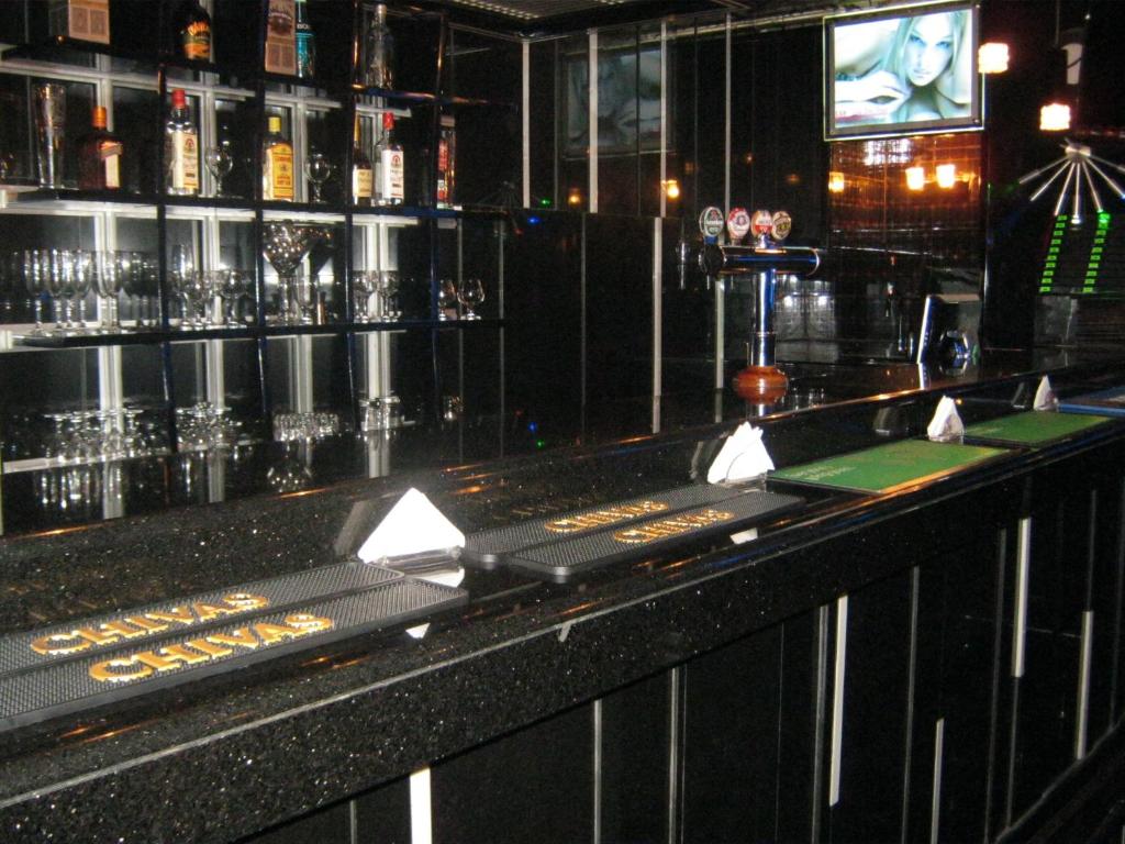 a bar with a black counter with glasses on it at Gulf Inn Hotel Deira Formerly City Star Hotel in Dubai