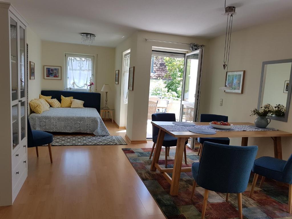 a bedroom with a bed and a table and chairs at Wohnung Seerose in Lindau