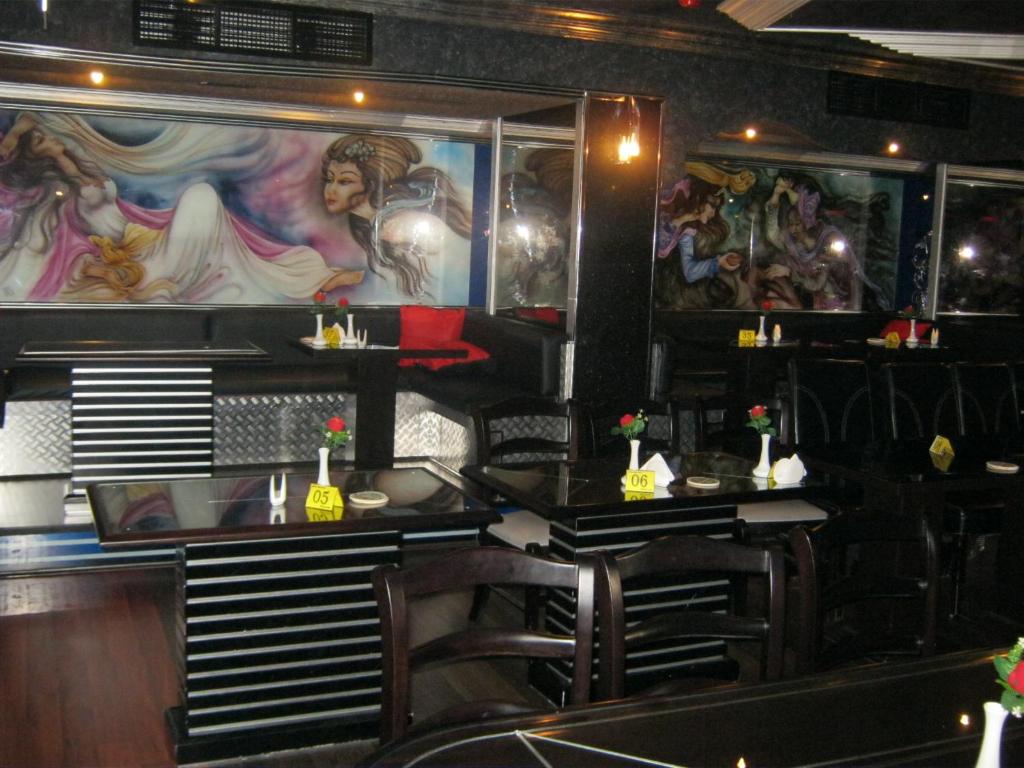 a dining room with a painting on the wall at Gulf Inn Hotel Deira Formerly City Star Hotel in Dubai