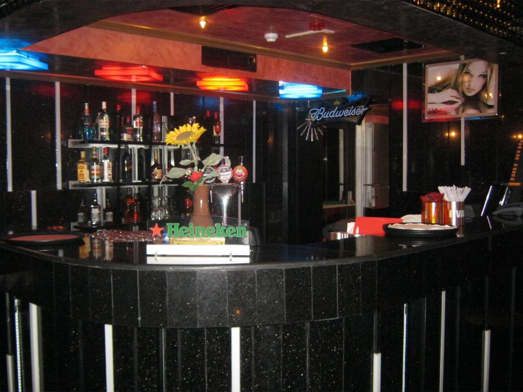 a bar in a restaurant with a counter with drinks at Gulf Inn Hotel Deira Formerly City Star Hotel in Dubai