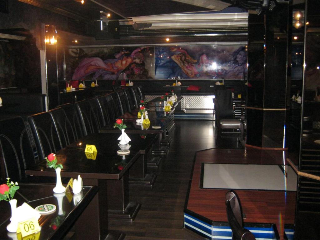 a row of tables and chairs in a restaurant at Gulf Inn Hotel Deira Formerly City Star Hotel in Dubai