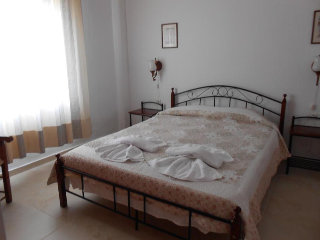 a bedroom with a bed with two towels on it at Villas Michalis in Chorafakia