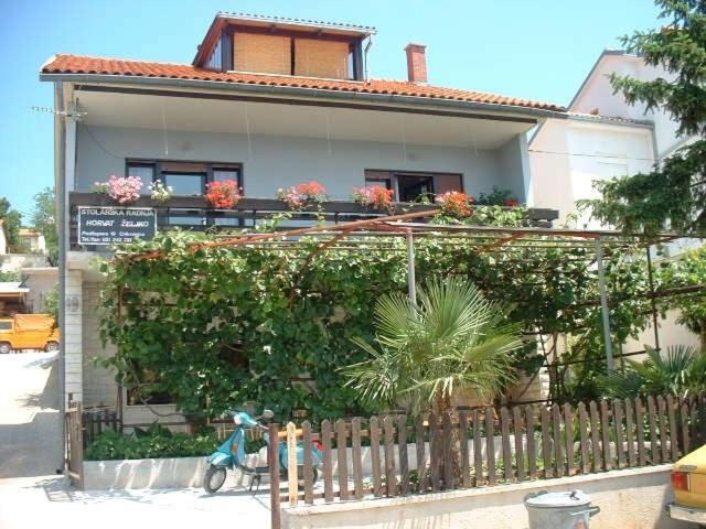 a house with flowers on the side of it at Apartments Horvat in Crikvenica