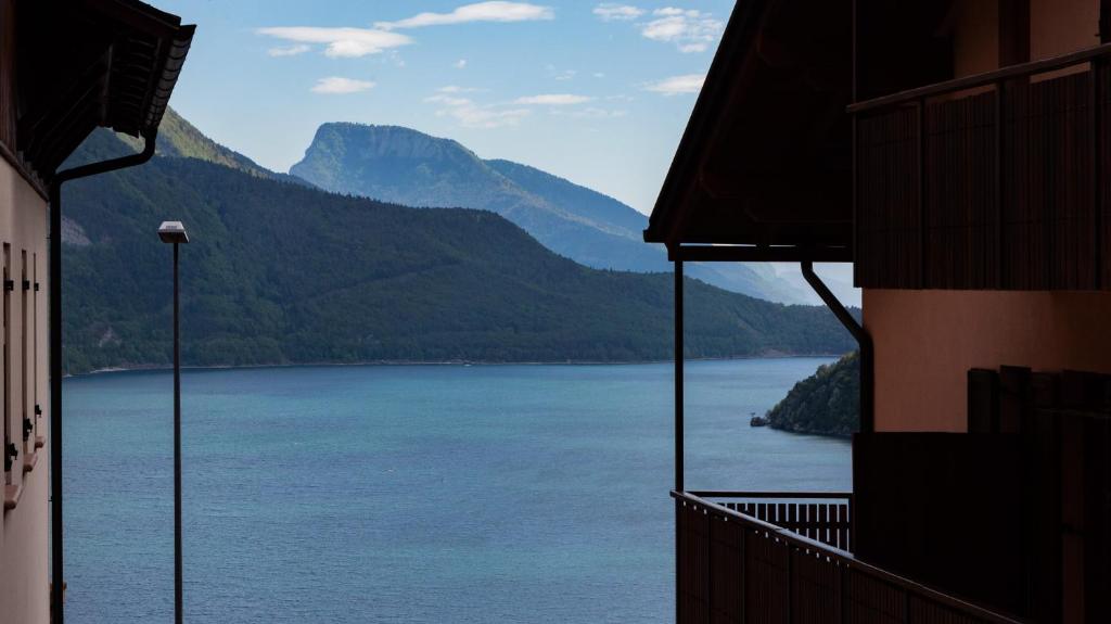 a view of a large body of water with mountains at Una Finestra sul Lago in Molveno
