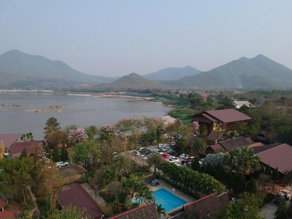 an aerial view of a resort with a river and mountains at Chiang Khan Hill Resort in Chiang Khan