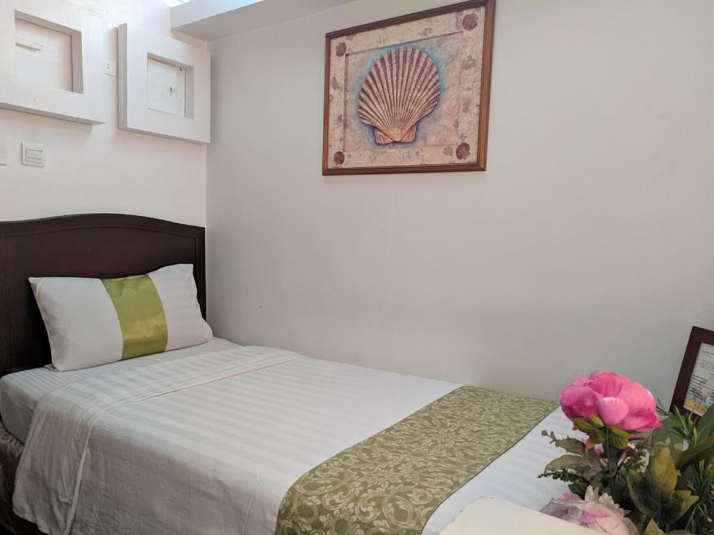 Postel nebo postele na pokoji v ubytování Comfy Inn Manila-Kalaw