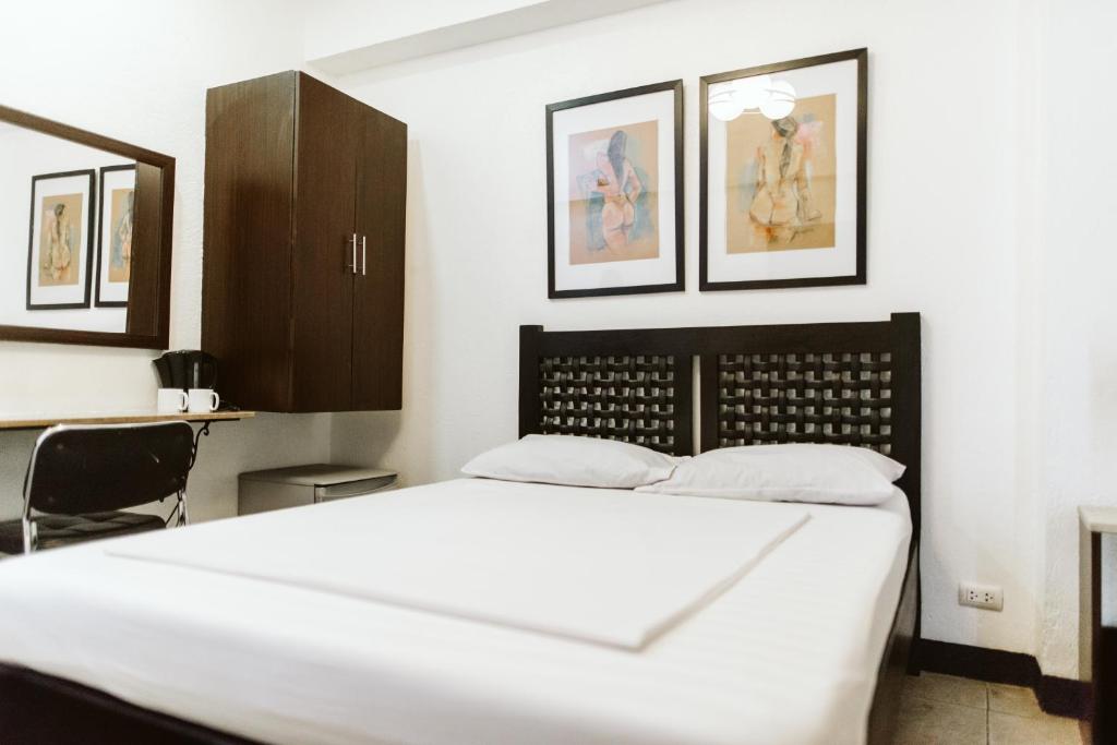 מיטה או מיטות בחדר ב-San Agustin Residences