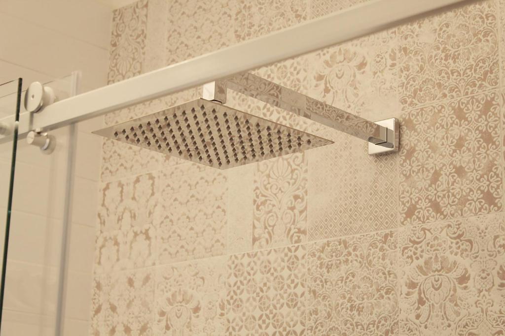 a shower curtain with a shower head in a bathroom at Estlevante B&B in Vieste