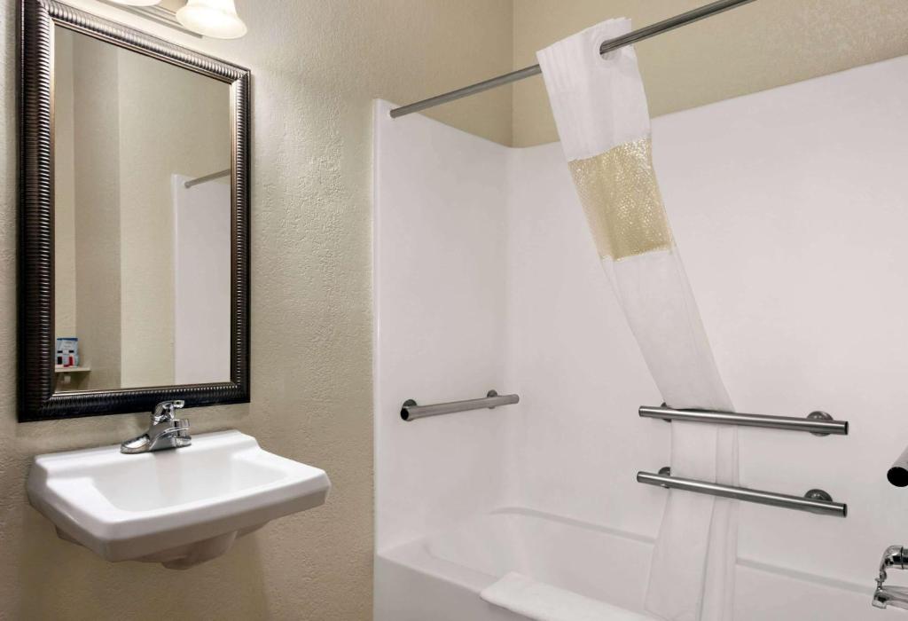 a bathroom with a sink and a mirror at Baymont by Wyndham Elizabethtown in Elizabethtown