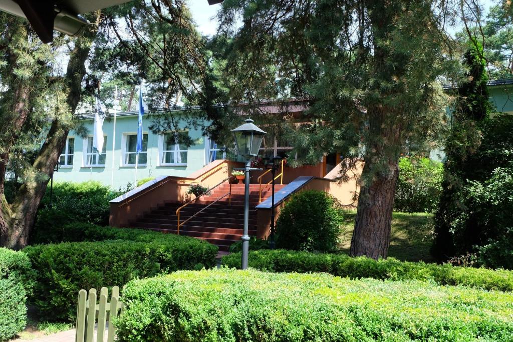 una casa con una escalera delante de ella en Leśny Ośrodek Szkoleniowy en Puszczykowo