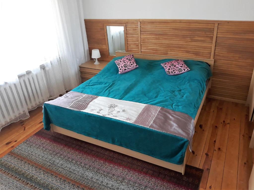 a bed with two pillows on it in a bedroom at Przy Starej Lipie in Augustów