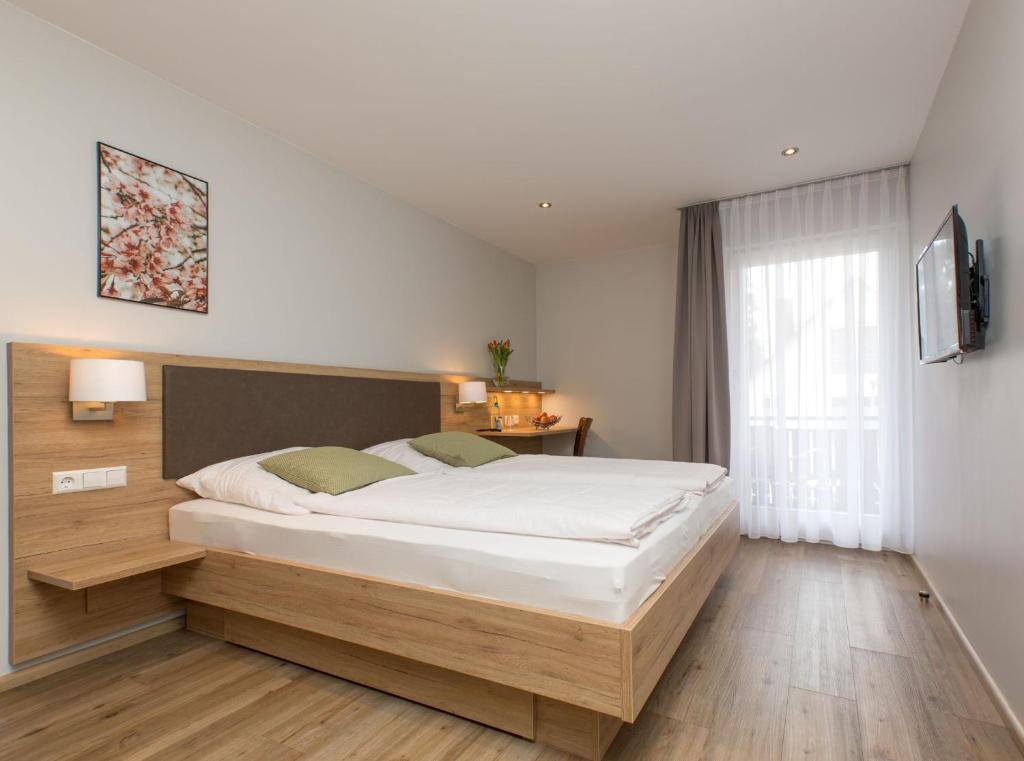 a bedroom with a large bed in a room at Restaurant & Appartements In Vino Veritas in Haslach im Kinzigtal