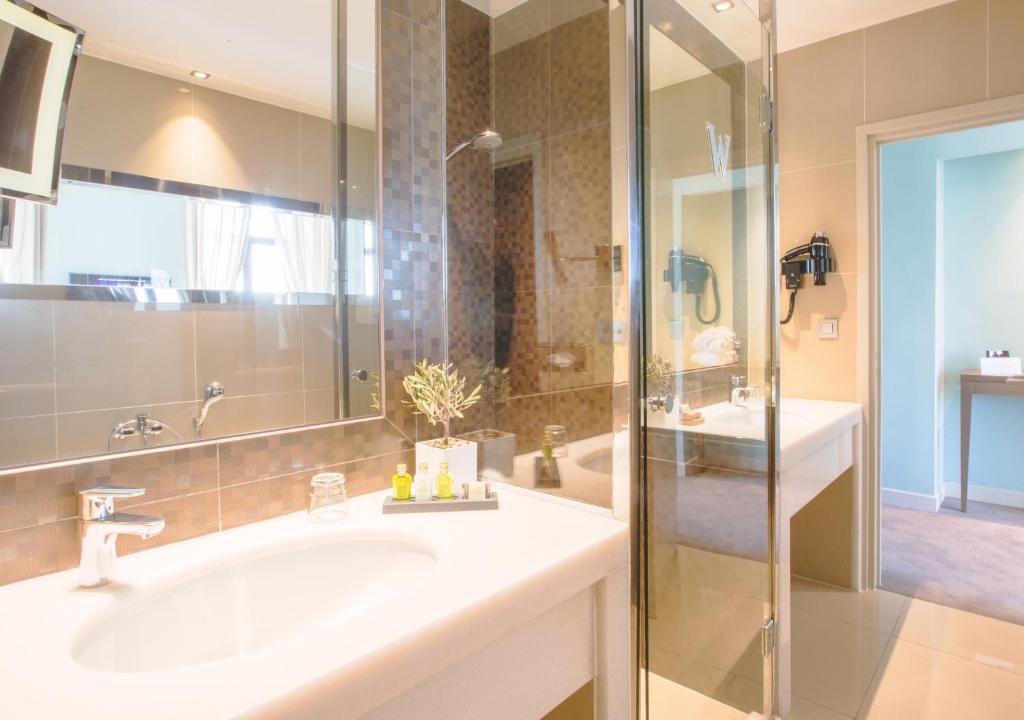 a bathroom with a sink and a shower at Westminster Hotel & Spa Nice in Nice