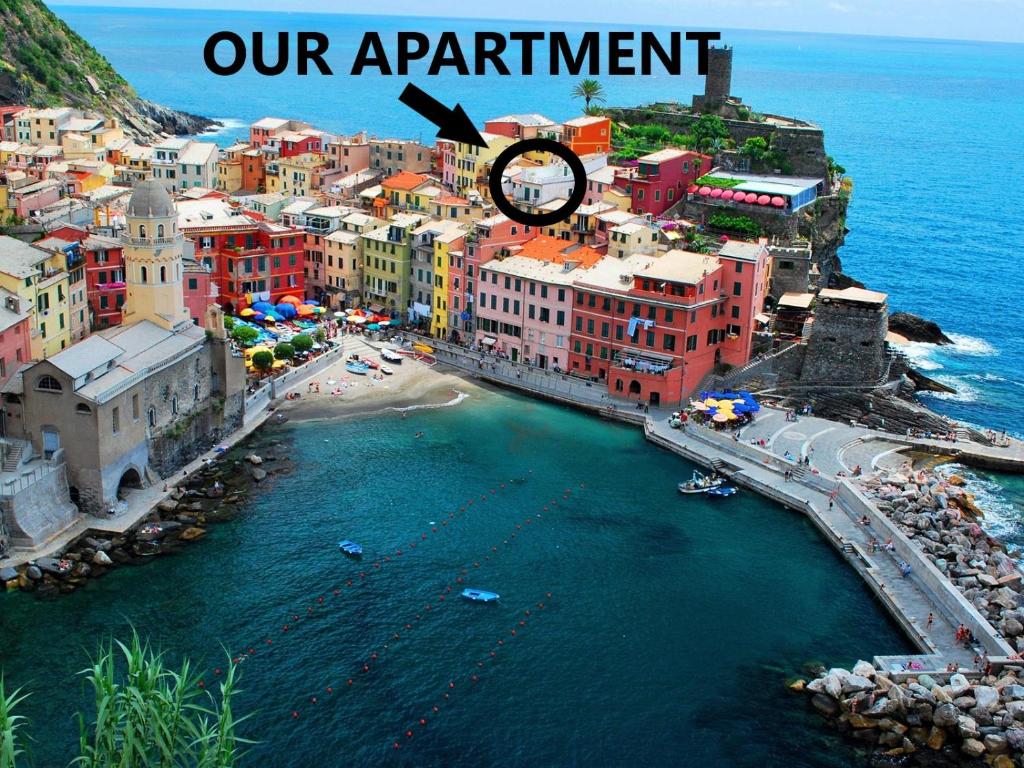 an aerial view of a city with a clock on top at MADA Charm Apartments Jacuzzi in Vernazza