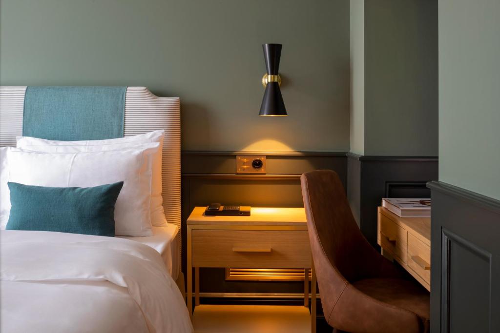Postel nebo postele na pokoji v ubytování Hôtel Longemalle