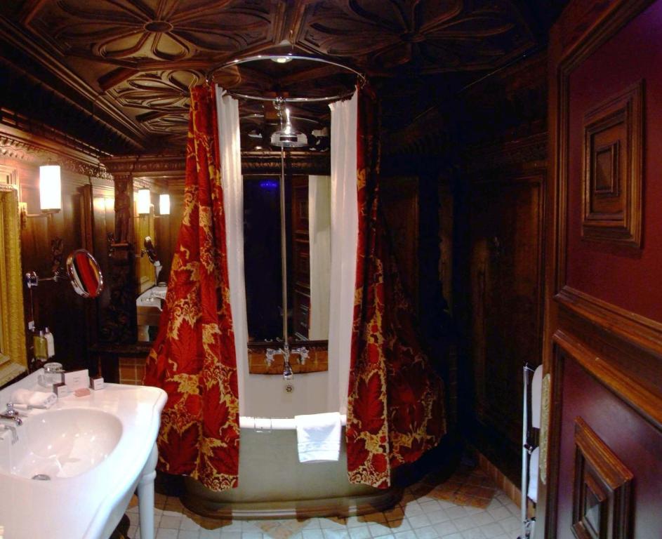 
a room with a bed and a dresser in it at The Witchery by the Castle in Edinburgh
