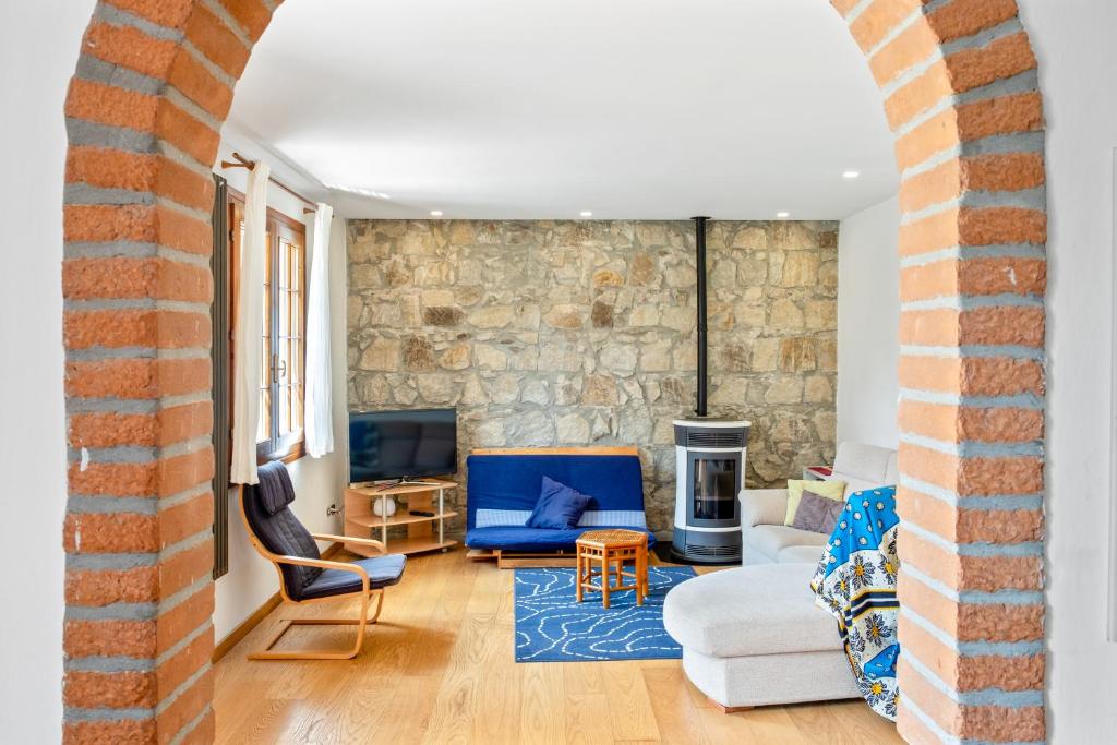 a living room with a stone wall at Casa Nespolo Abano Terme in Abano Terme