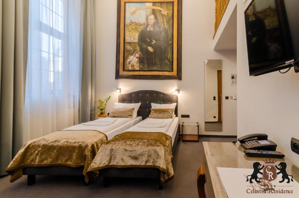 Säng eller sängar i ett rum på Celestin Residence