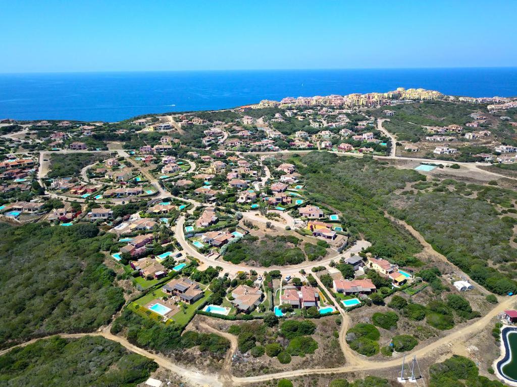 an aerial view of a village on a hill near the ocean at Stintino Country Paradise - Resort & Villas in Stintino